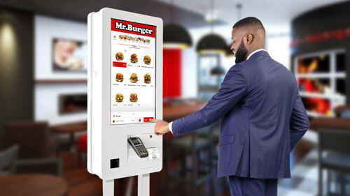 Man ordering on Nummax self-service kiosk
